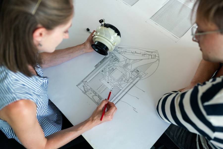 BIM modeler drafting at a standing desk