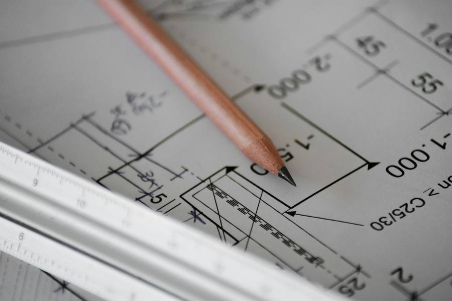 CAD blueprint drafting with pencil and ruler